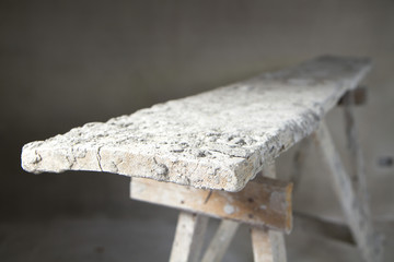 Dirty wooden table in empty room at construction site