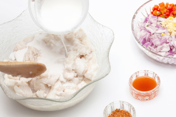 Peruvian ceviche preparation : Add coconut milk to the marinated fish