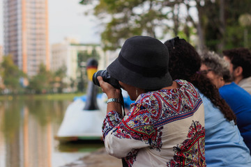 Photographers logging birds on a late afternoon by a lake