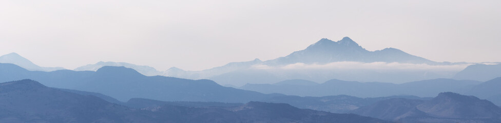 Mountain peaks and valleys shrouded in fog and clouds