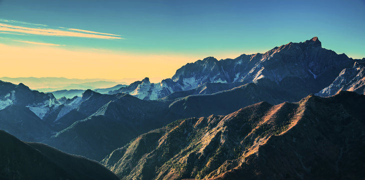 Alpi Apuane mountains and marble quarry view at sunset. Carrara, Tuscany, Italy.