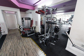 Fototapeta na wymiar Interior Of New Modern Gym With Equipment