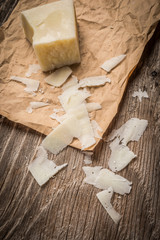 Fototapeta na wymiar Parmesan cheese shavings on rustic background