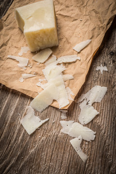 Parmesan cheese shavings on rustic background