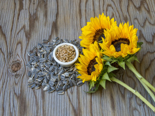 Organic sunflower seeds on wood table.