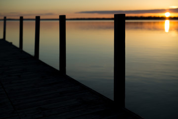 Silhouette of pier at sunrise