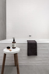 White bath hob and stool with soap day spa bathroom