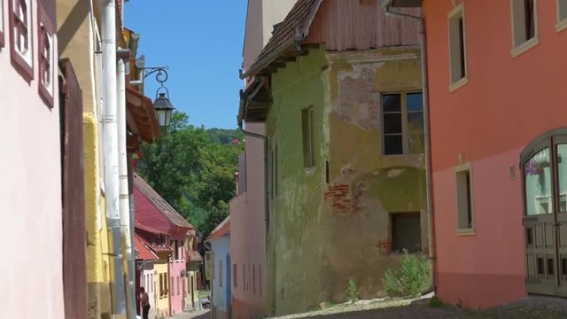 street in a historical part of the city of Sighisoara in bright sunny day, Romania