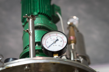 Fototapeta premium Pressure gauge, measuring instrument close up on pneumatic control system.