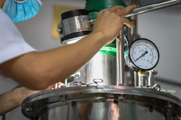 Closeup Asian worker working with ferment machine