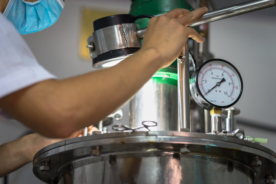 Closeup Asian worker working with ferment machine