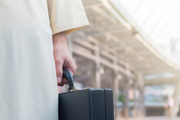 The arabian businessman holding the .briefcase in the city