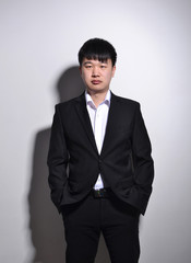 Young Asian business man portrait on white background.