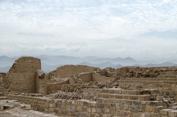 Inca ruins under cloudy sky