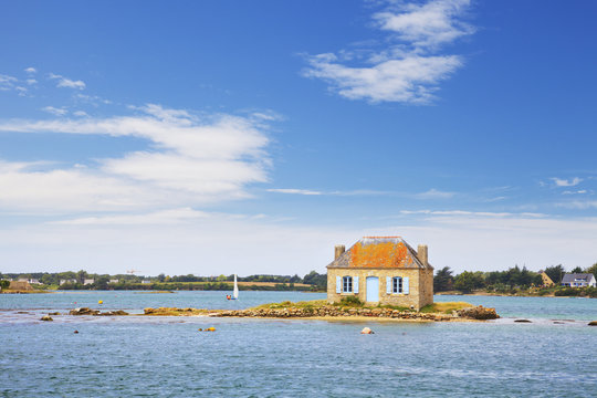 Ile de Saint-Cado, Brittany, France, a small island with a cottage on it in the Etel River.