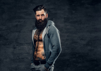 Athletic bearded male in a grey hoodie.