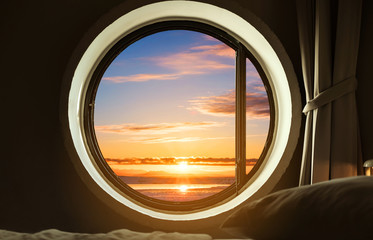 Interior bedroom circle window with beautiful sunrise view 