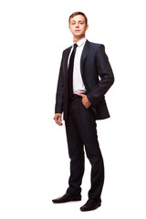 Stylish young man in suit and tie. Business style. Handsome man standing and looking at the camera
