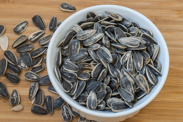 sunflower seeds in a white bowl.