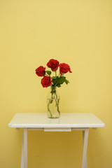 isolated red rose flower with green leaves