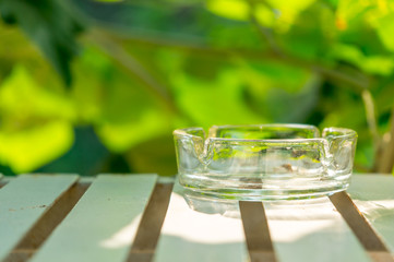 Ashtray made of glass on table
