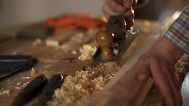 Carpenter planed wood, workplace. Slow motion