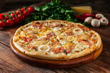 Appetizing pizza on wooden rustic background with ingredients. Traditional italian food, restaurant menu photo.