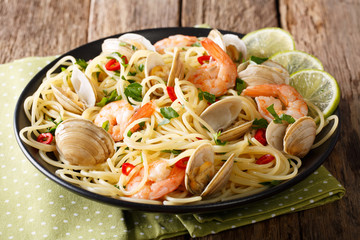 Pasta spaghetti with clam, shrimp, chili and lime close-up. horizontal