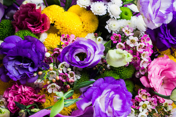 Bouquet with a lot of different flower on the wooden background. Shallow depth of field.