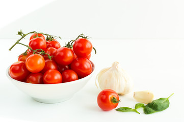 Italian red tomatoes close up food with garlic, basil leafs, isolated on white background