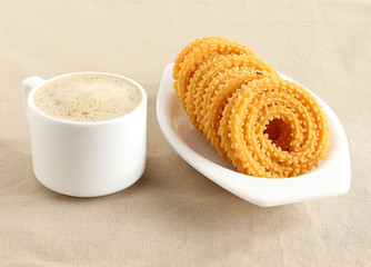 Chakli, also known as murukku, which is a south Indian traditional, popular and vegetarian snack, and coffee.