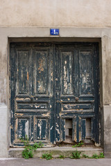 Old damaged front door in Paris, France