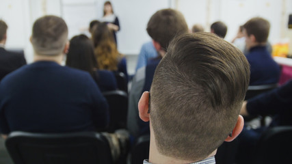 lecturer tells presentation on the scene to packed house of listeners