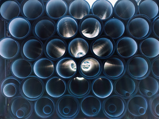 background of colorful big plastic pipes used at the building site.