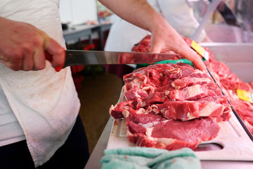 Butcher Cuts Meat in market