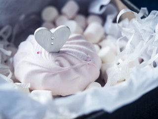Wooden heart on a marshmallow in a box