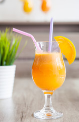 Orange juice in glass with fresh fruits on glass. Selective focus