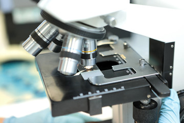 Fototapeta na wymiar Medical microscope. Professional pharmaceutical microscope. Study of the properties of the drug when increasing. The person analyzes the components of the medicine.