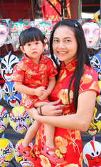 Asian woman and her daughter In Tradition Chinese dress, Chinese new year.

