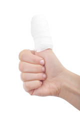 Injured finger with bandage on white background