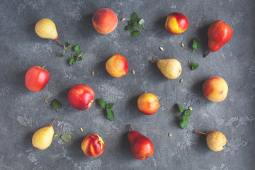 Fruits on black background. Pears, apples, peaches, nectarines. Fruit pattern. Flat lay, top view