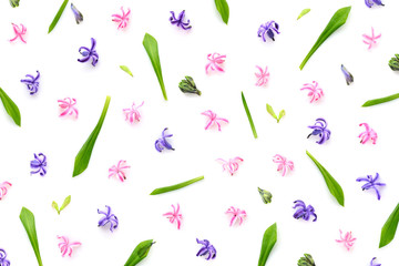 Floral pattern made of hyacinths flowers, green leaves, bud on white background. Top view. Pattern of flowers.
