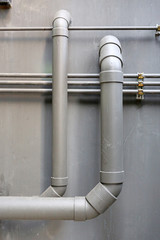 water pipes hanging on cement ceiling of building