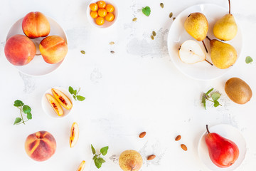 Fresh fruits. Peaches and pears on white background. Flat lay, top view, copy space