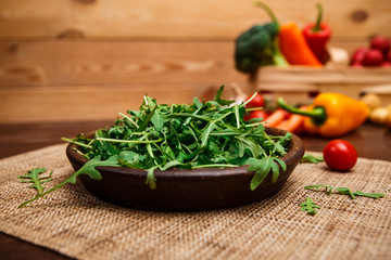 Green arugula leaves in bowl. Fresh salad.