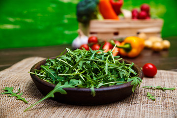 Green arugula leaves in bowl. Fresh salad.