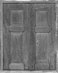 The Black and white image of external wood windows of a vintage house