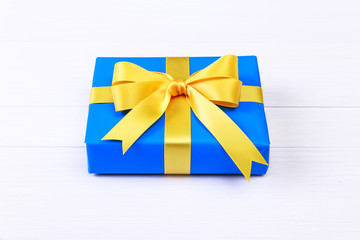 Gift box with yellow bow. Blue present package.