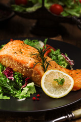 Baked salmon served with fresh vegetables.