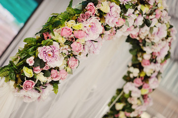 flowers on a wedding arch in frieze tones, background